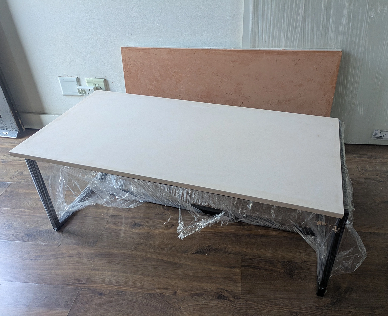KATACHI Coffee Table physical prototype showing GFRC top and steel frame during development