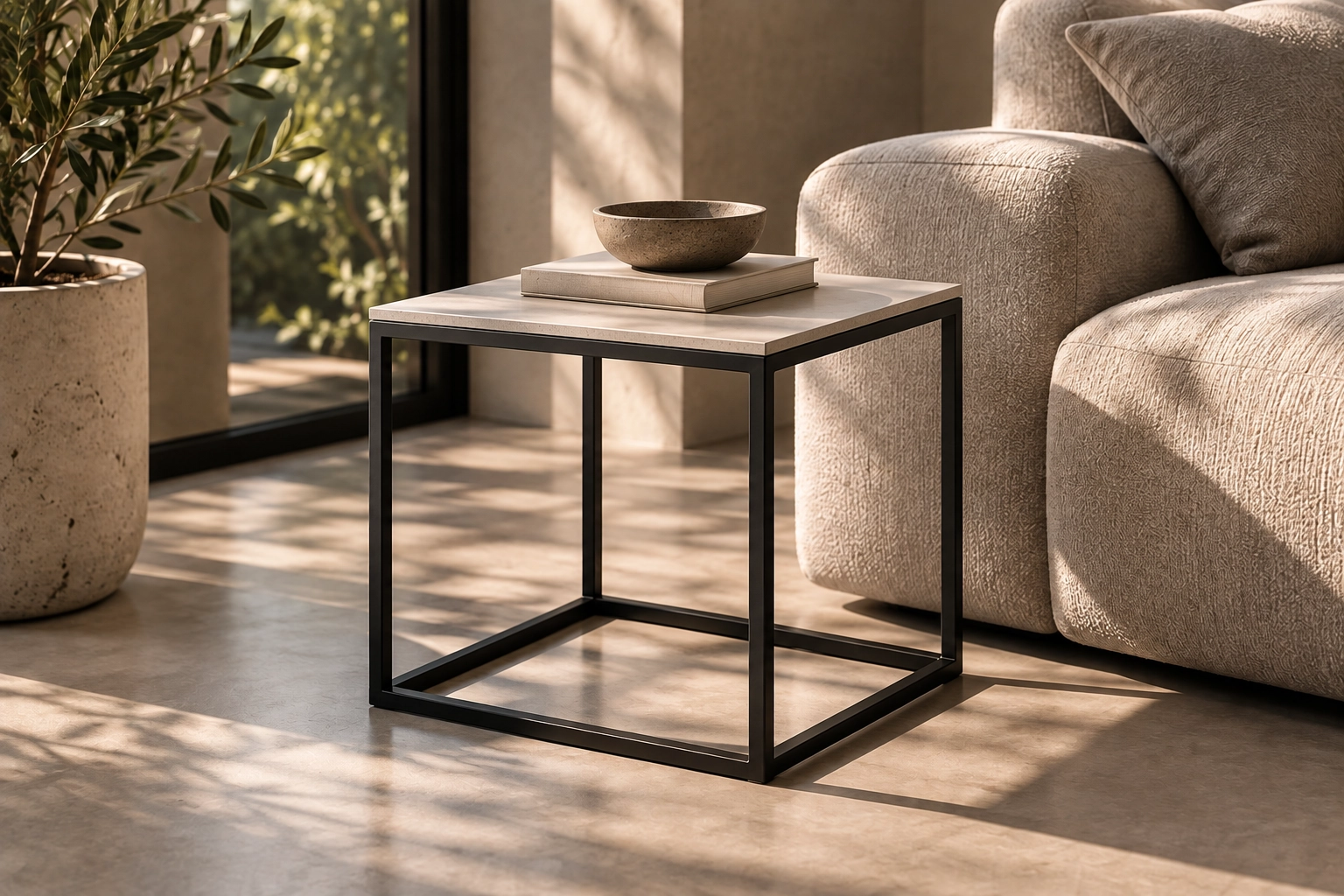 KATACHI Side Table with a thin mineral-toned GFRC top and matte-black steel frame in a warm contemporary living room